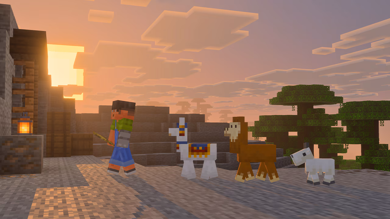A Minecraft player walks in front of two baby llamas and a white baby goat at sunset. Blocky trees and buildings sit nearby. Warm light from the square sun casts long shadows.