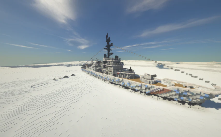 Image of an abandoned ship in the arctic tundra, covered with ice and snow, surrounded by a few smaller buildings to the left.