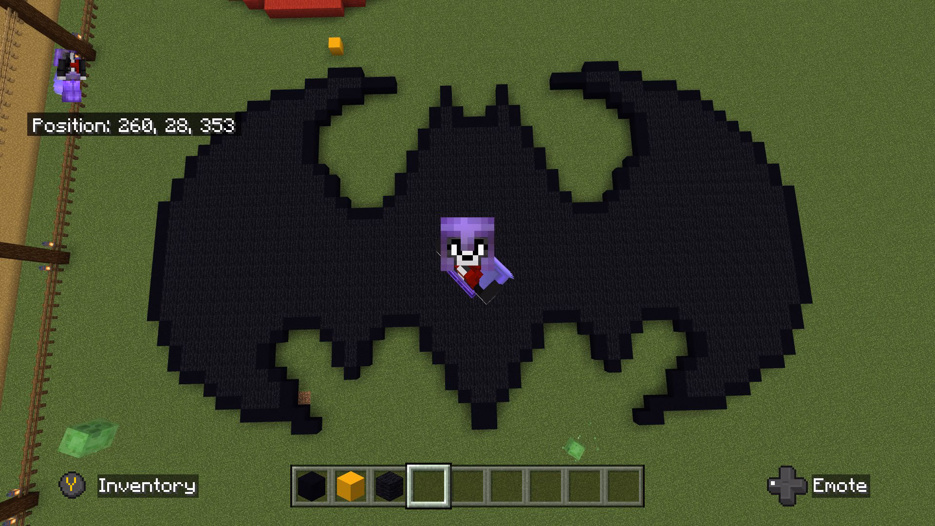 Overhead image from Minecraft of a black pixel art version of the Batman logo