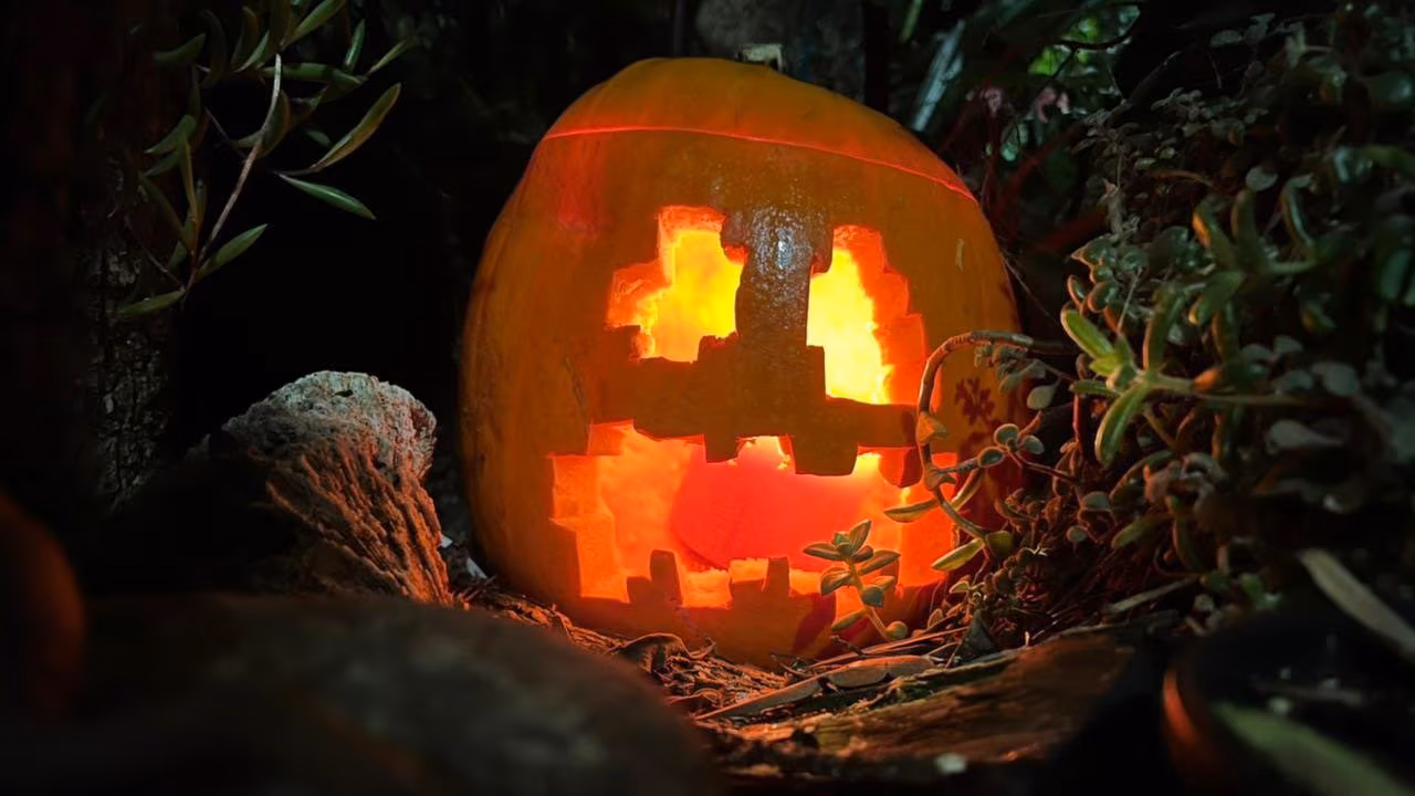 Photo of a jack-o-lantern carved with some Minecraft-esque cutouts for the eyes and mouth