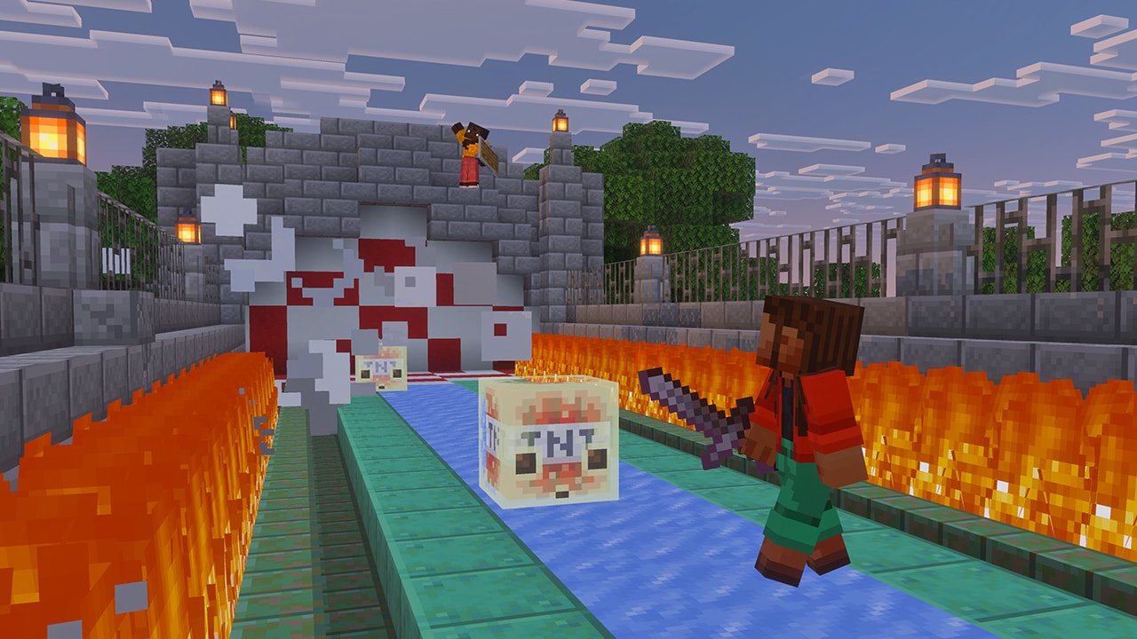 Two characters playing with two TNT-filled sulfur cubes that are sliding on an ice track lined with flames.