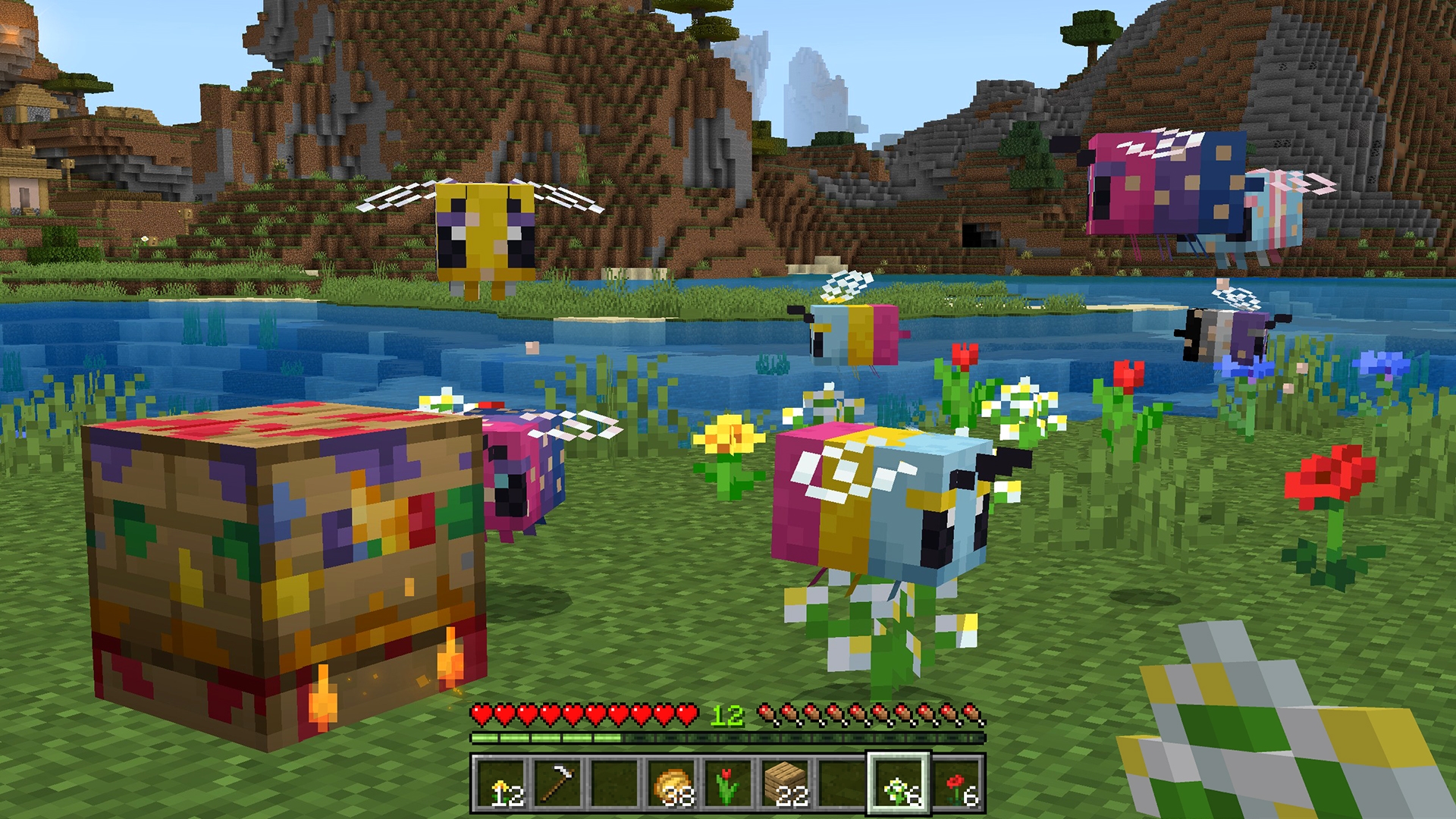 Colorful Minecraft bees gather around flowers and a decorative beehive beside a river, with mountains rising in the background.