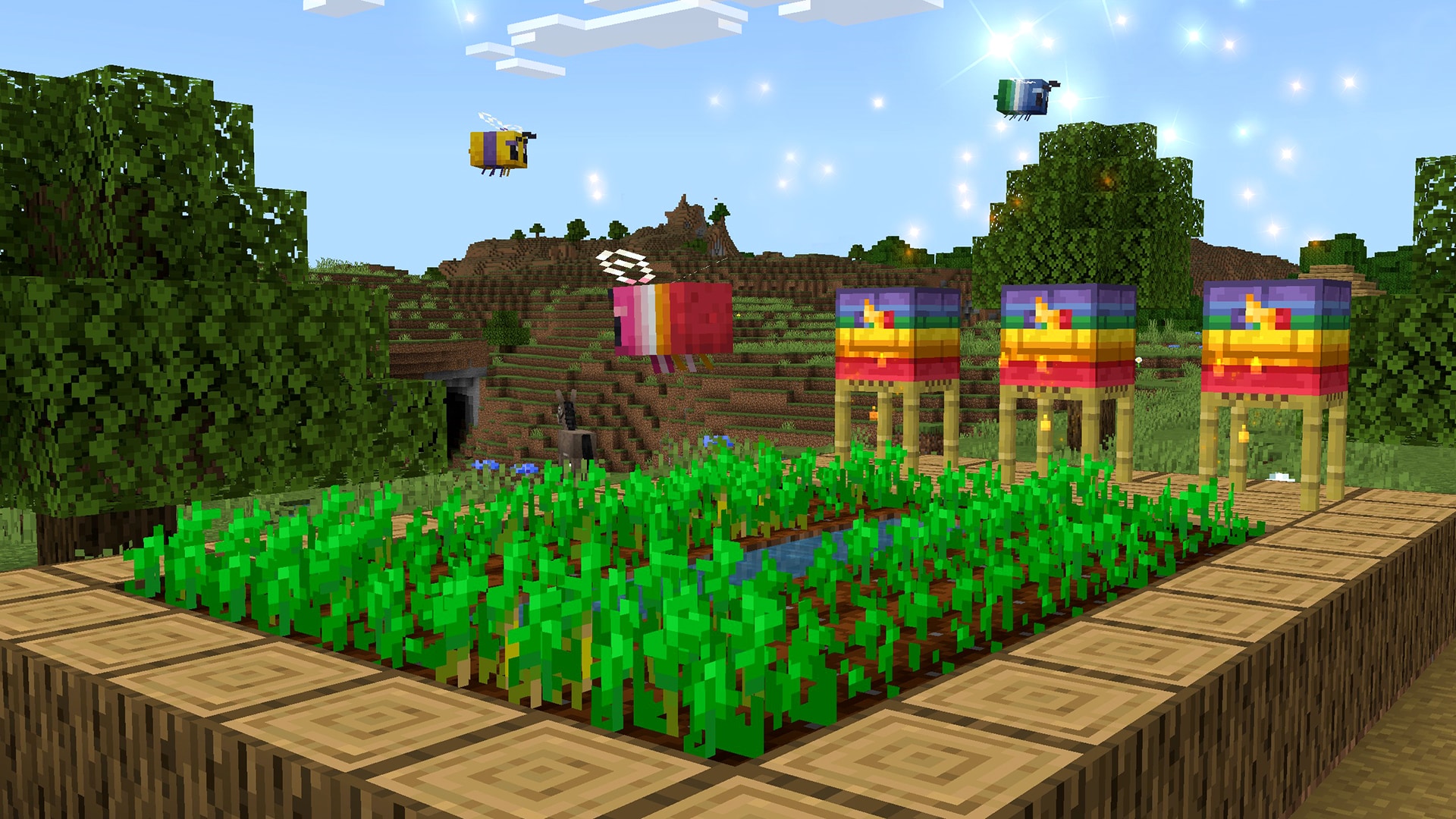 Rainbow-themed beehives stand beside a thriving crop field while colorful bees buzz overhead under a bright daytime sky.