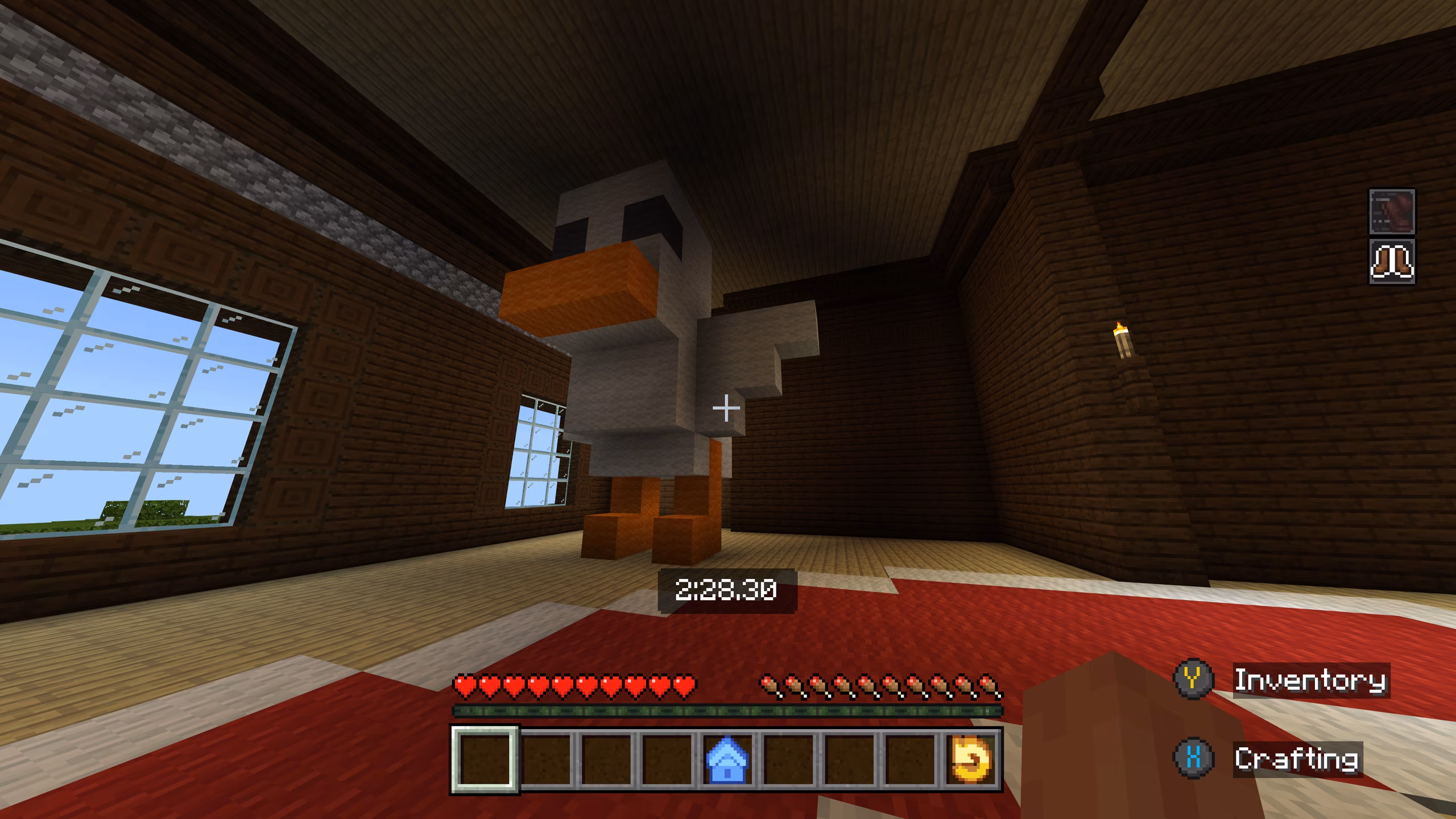 A screenshot of a giant chicken made out of blocks to the side of a parkour course.