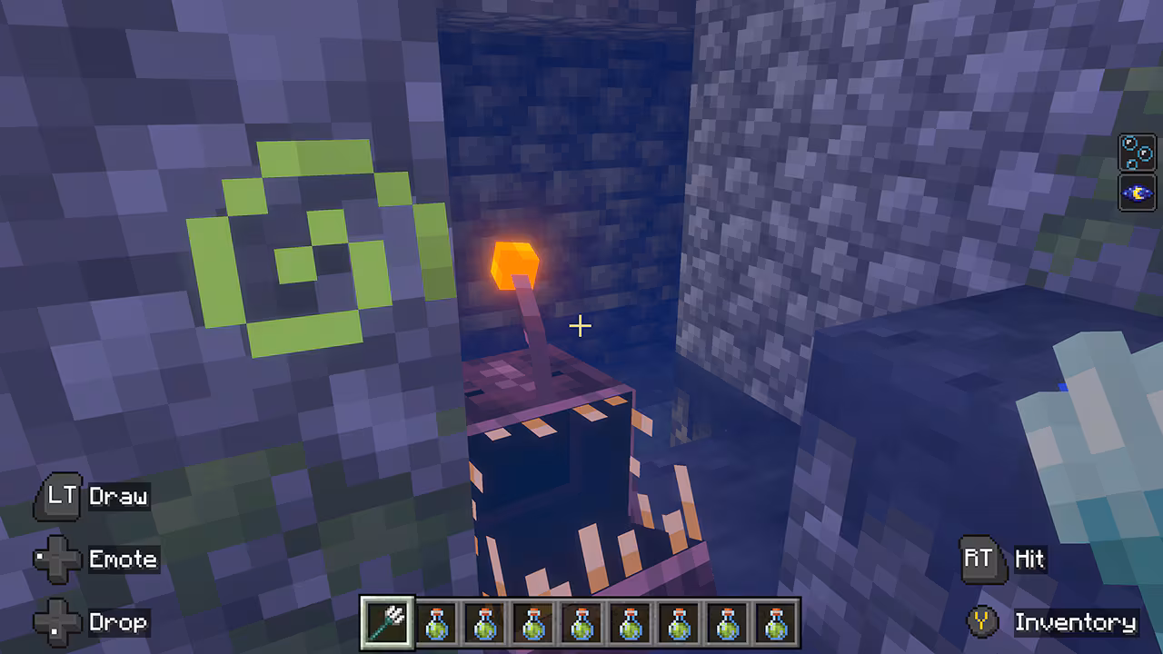 A small bioluminescent sea creature hides between stone blocks in an underwater structure, glowing with a bright orange lure.