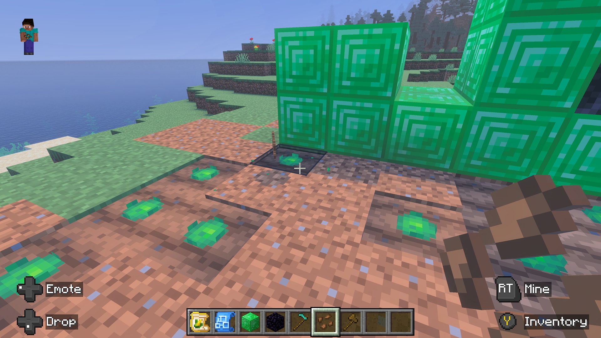 Close-up of tilled farmland with young crops growing beside a green block structure. A farming tool is selected.