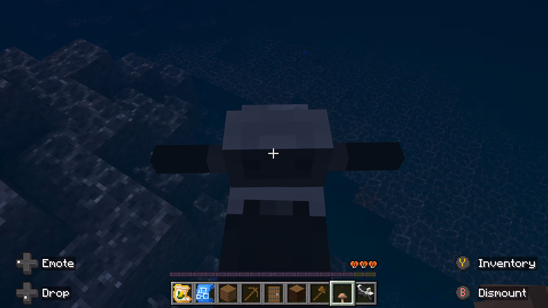 Top-down view of a small farming vehicle moving underwater near a rocky seabed in a dark ocean.