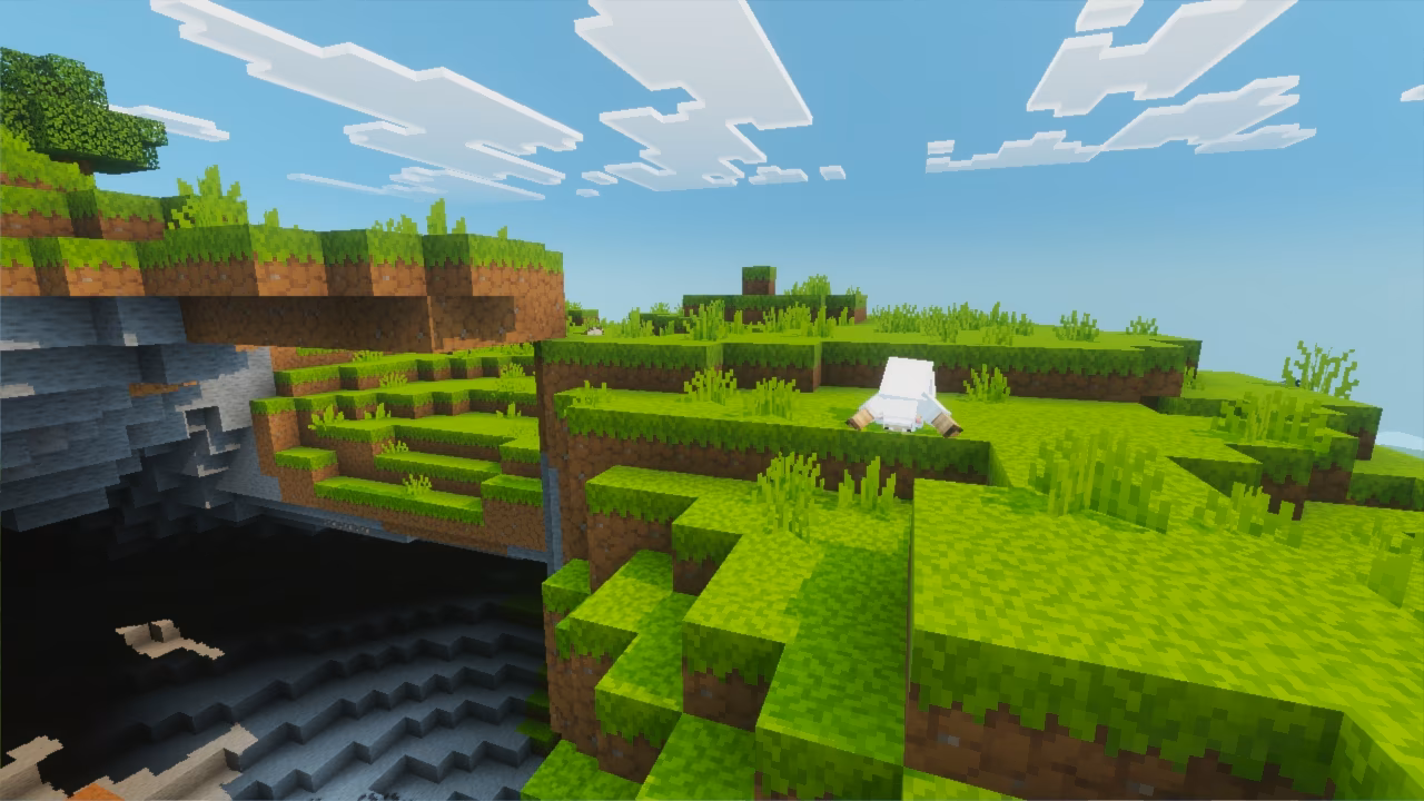 A blocky sheep grazes on bright green grass near the edge of a cliff overlooking a deep cave and rolling hills