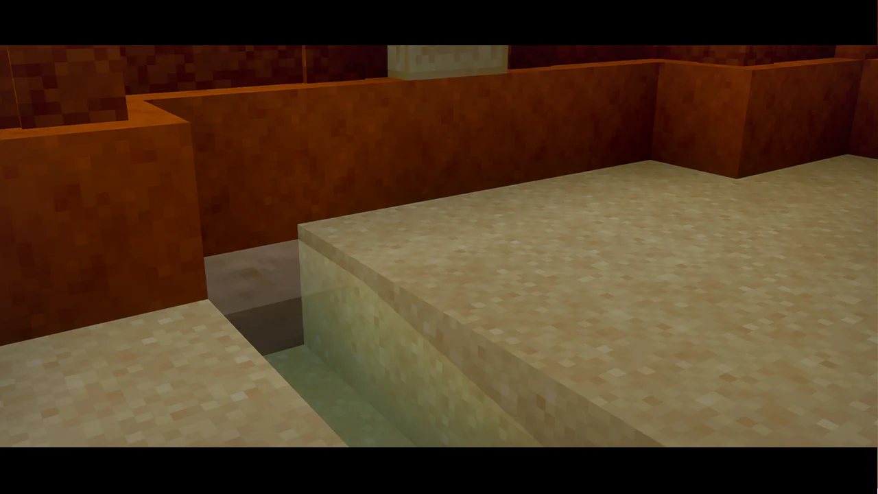 Sandstone arena floor with a shallow water channel running along the edge. Orange walls frame the scene, adding contrast to the pale sandy surface.