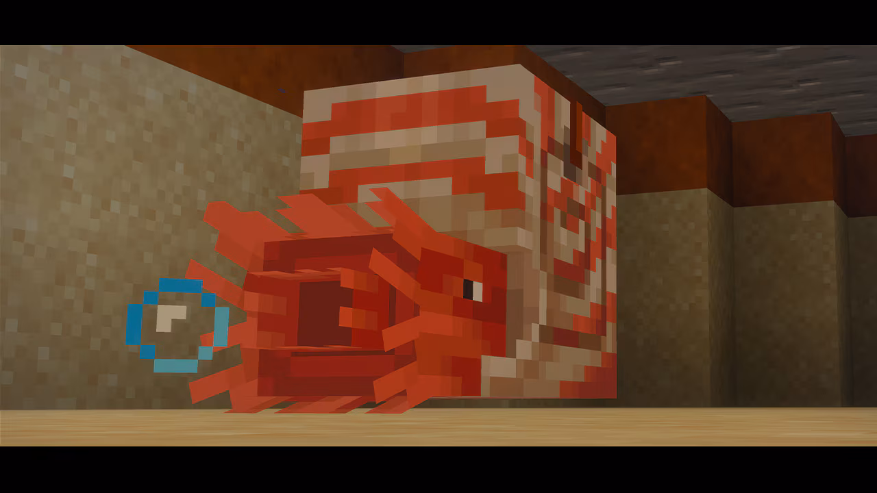 Close-up of a red nautilus-like creature with spiral shell and frilled tentacles resting on a sandy floor inside a Minecraft structure