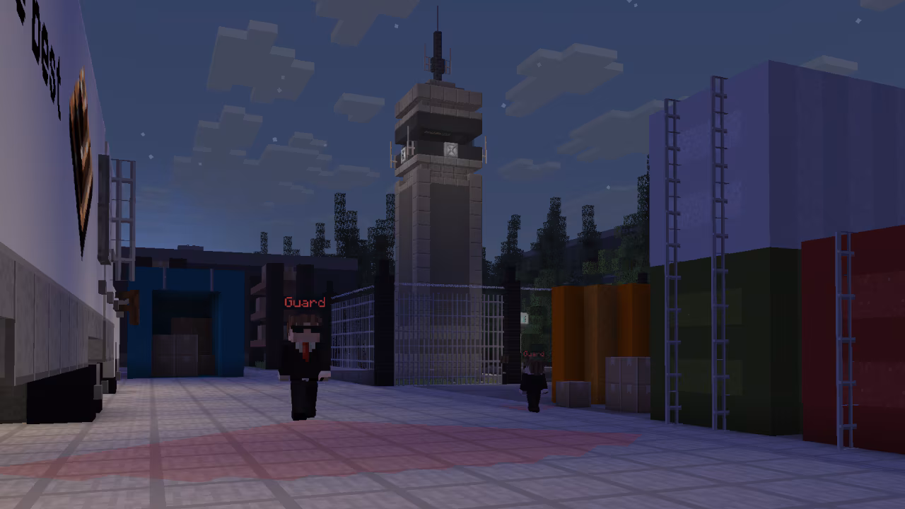 A secure facility with guards, watchtower, and fenced compound.