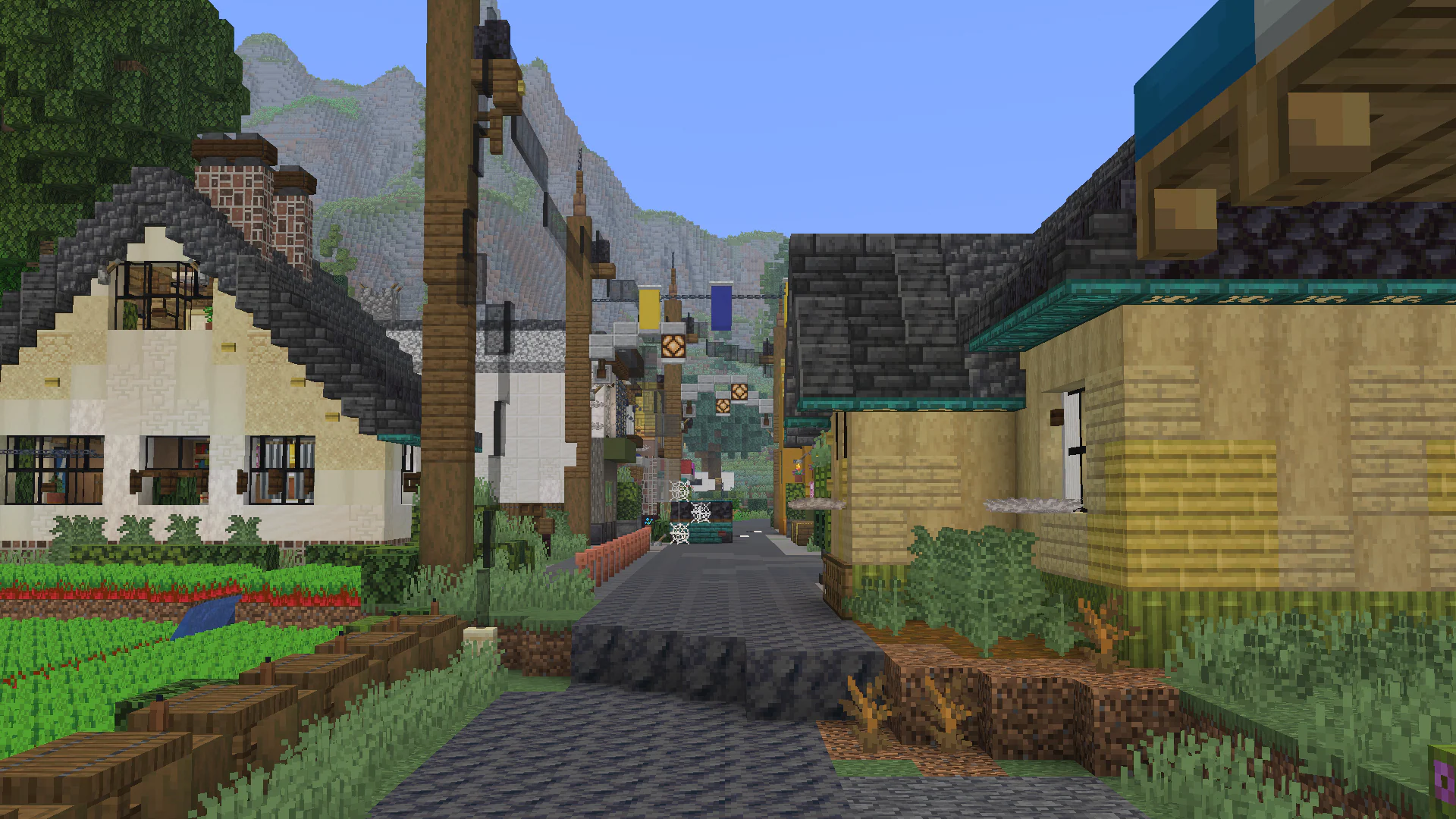A quiet town street with wooden signs and hillside backdrop.