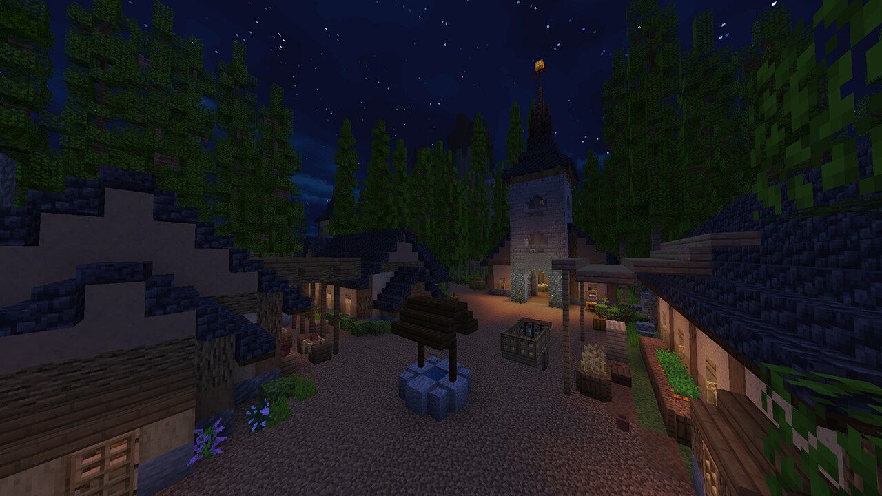 A church and village lit up by lanterns at night