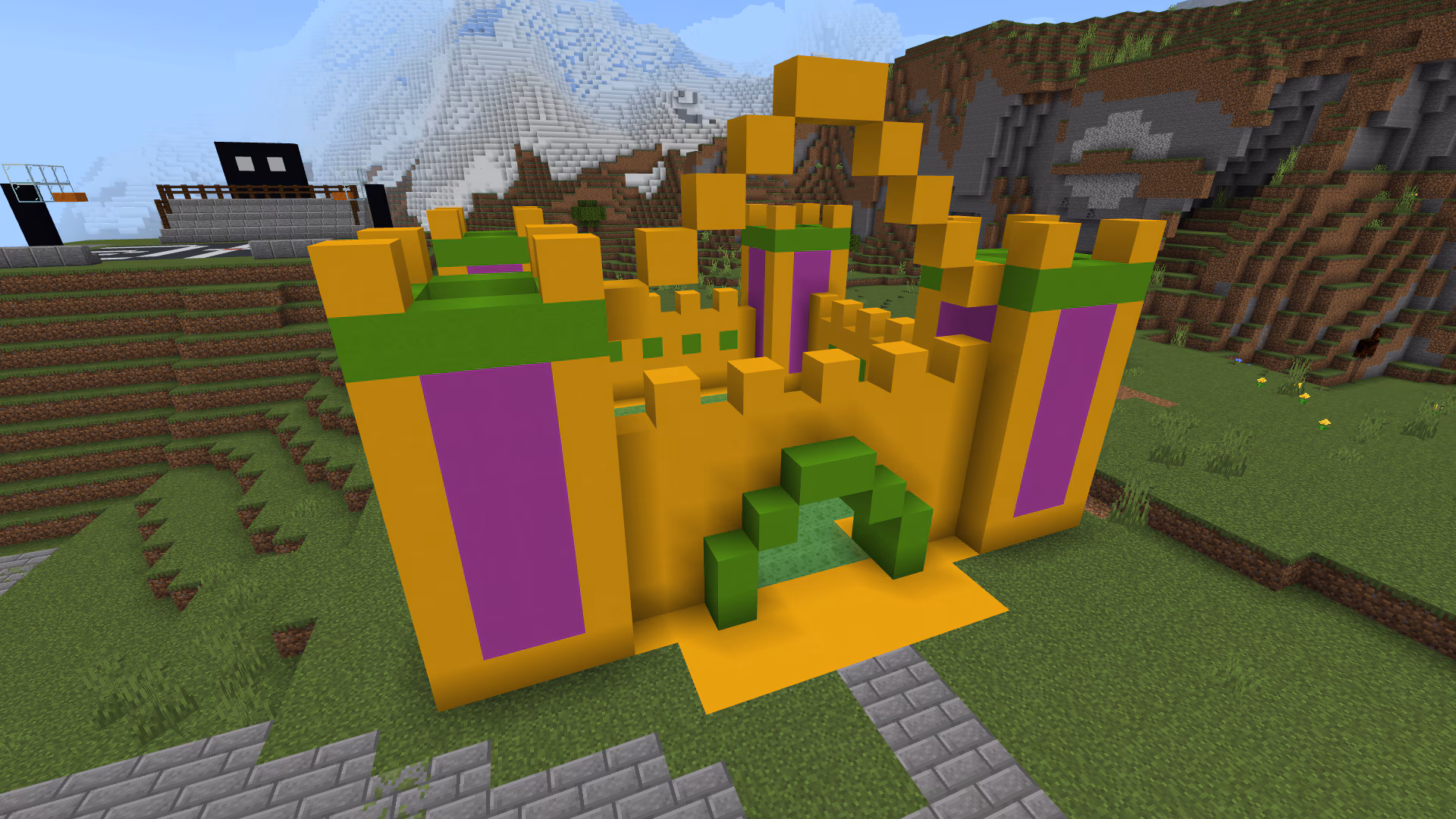 Image created in Minecraft of a large bouncy castle in yellow, purple, and green colors.