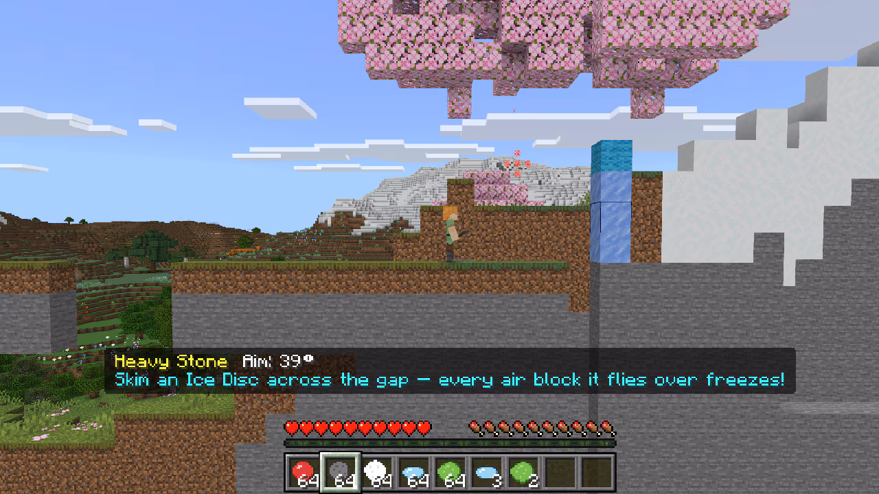 Player prepares an ice disc shot across a gap; frozen blocks create a path through a snowy Minecraft landscape.